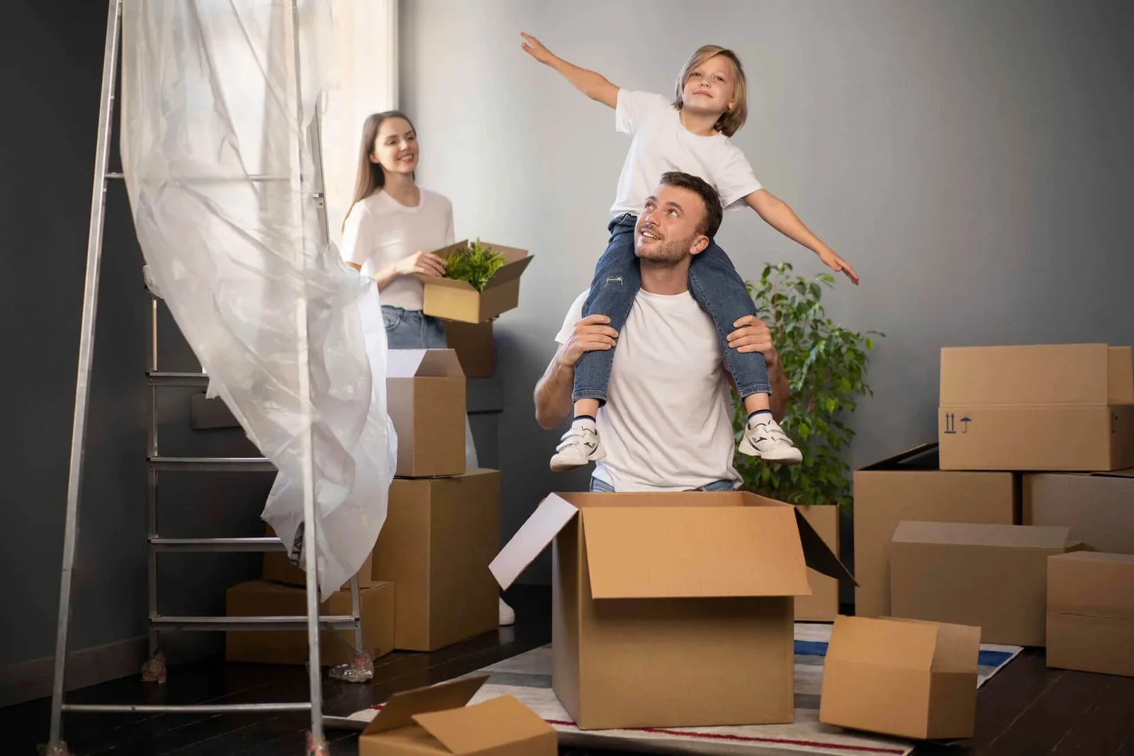 Family unpacking cartons in the lounge of their new home